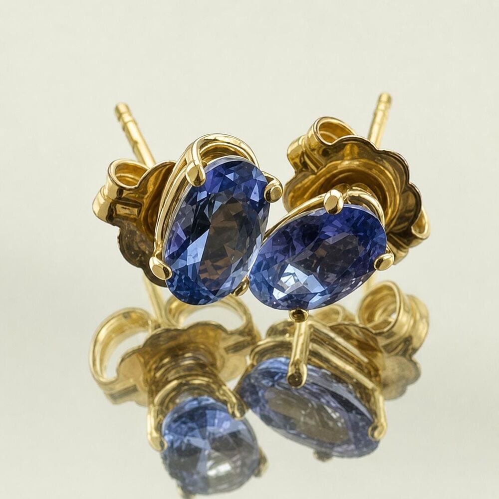 Natural Tanzanite oval stud earring 14kt yellow gold .66cts. 5x3mm